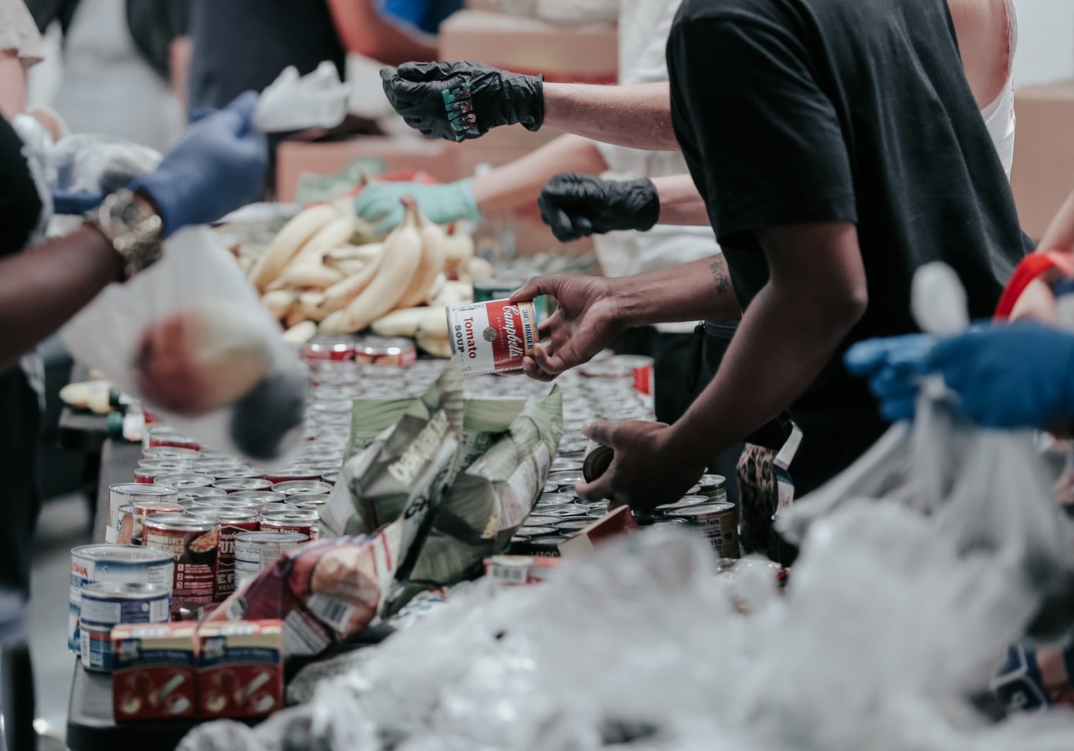 man in black t-shirt holding coca cola bottle